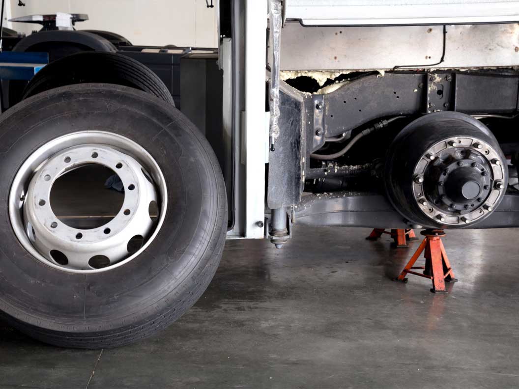 Tire rotation being performed at a bus and truck mechanic shop. 