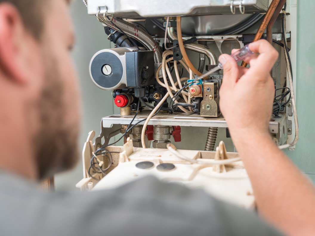 HVAC mechanic installs electrical components and checks wiring. 
