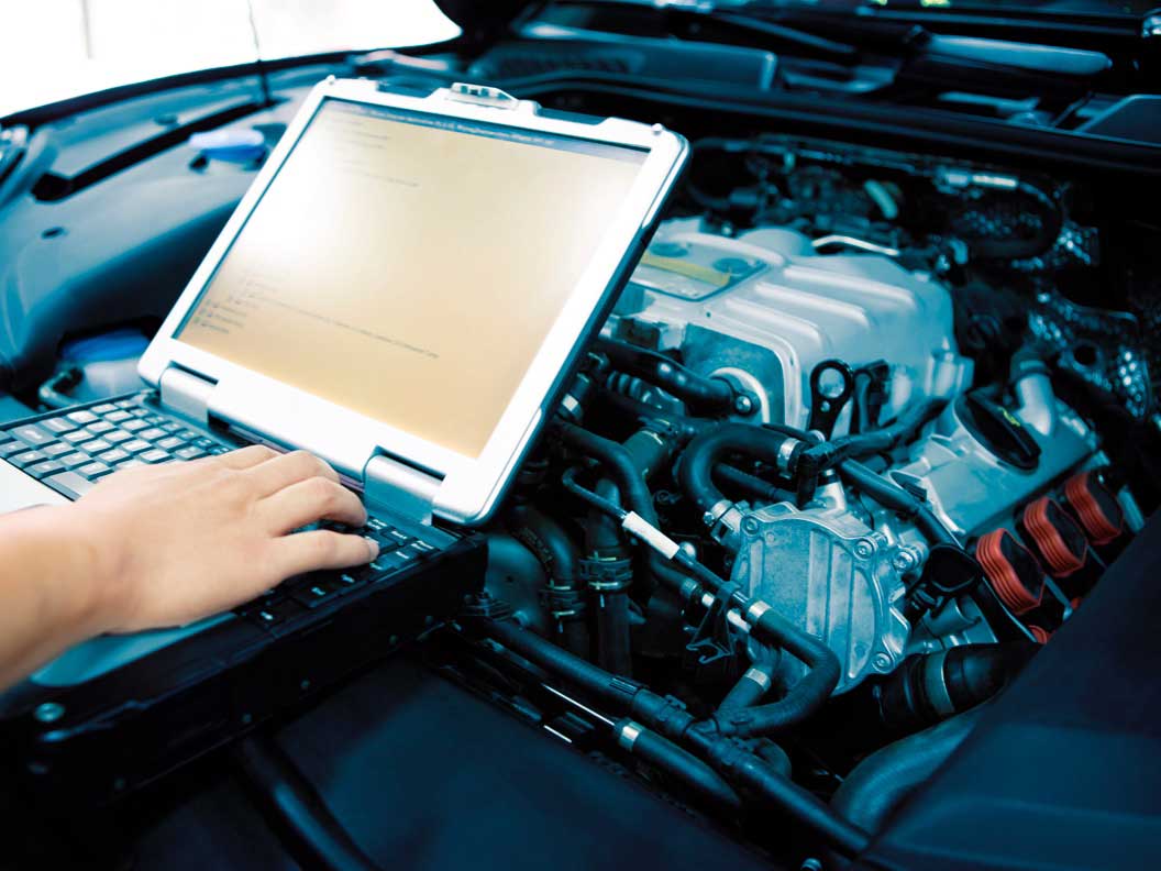 Diesel engine specialist running a diagnostic test to find mechanical problems. 