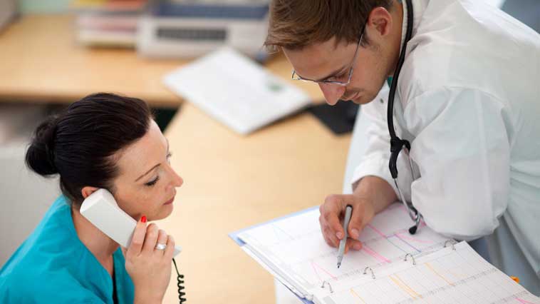 Cardiovascular technologist assists doctor with scheduling patient appointments.