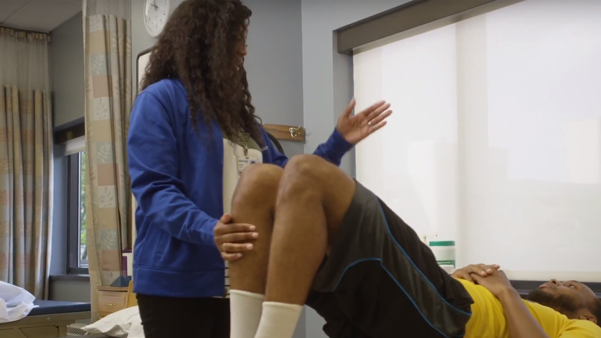 A physical therapist assistant working with a patient.