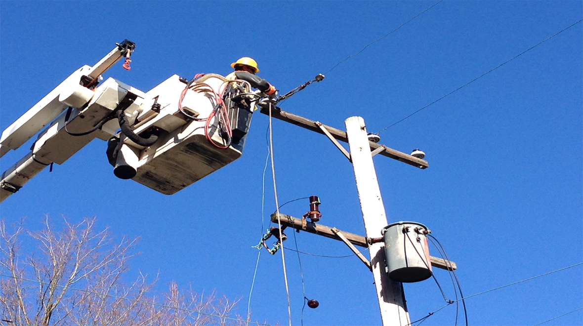 A Consumer Energy Lineman working in a bucket truck.
